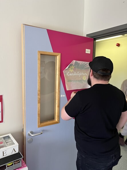 An image of a guy installing door graphics.